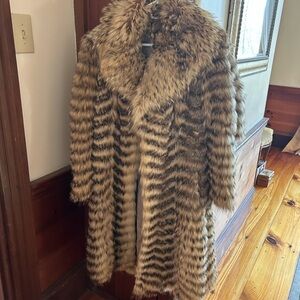 This coat is from Alaska Fur Gallery.  It is real fur from Fin Raccoon.